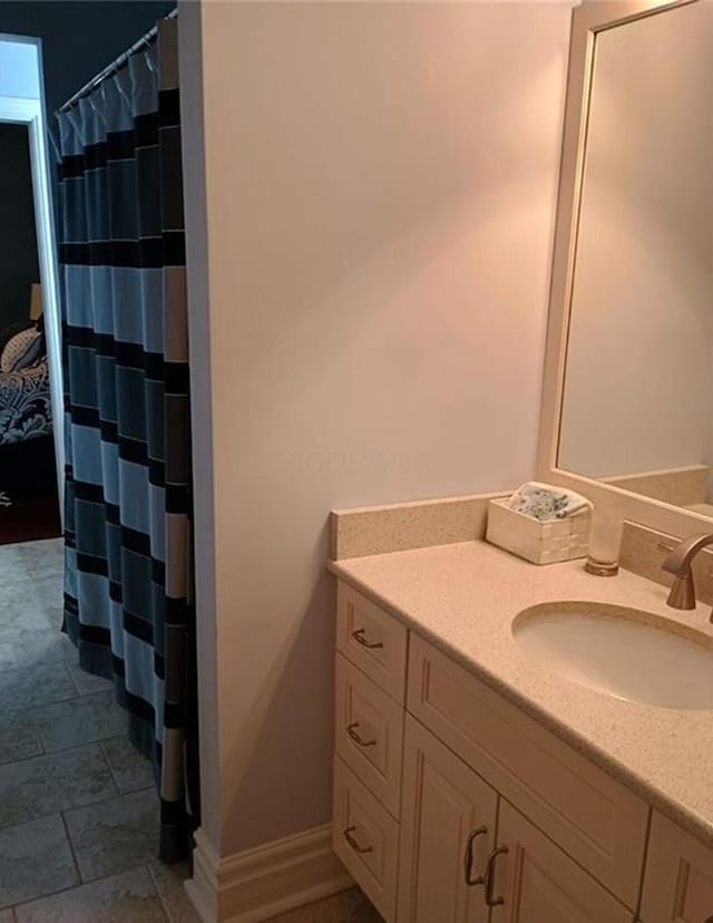 full bathroom featuring baseboards, vanity, and a shower with curtain