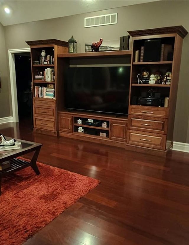 living area with visible vents, baseboards, and dark wood-style flooring