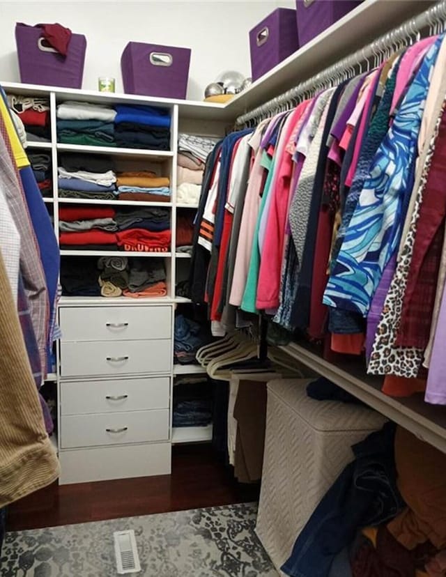 walk in closet featuring wood finished floors and visible vents