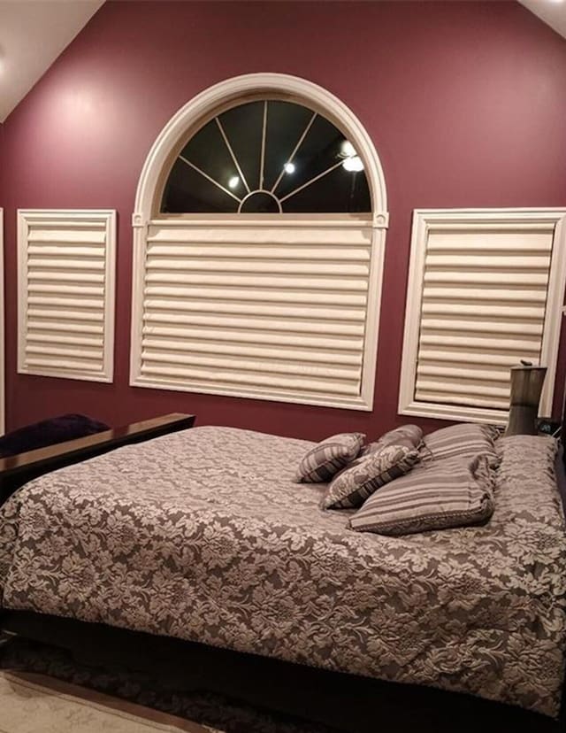 unfurnished bedroom with lofted ceiling