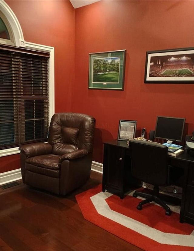 home office with visible vents and dark wood-style flooring