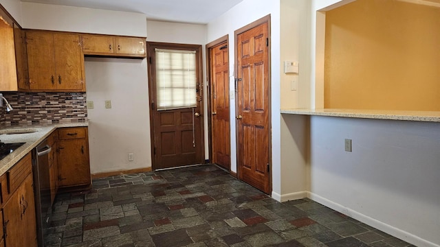 kitchen with sink, decorative backsplash, and dishwasher