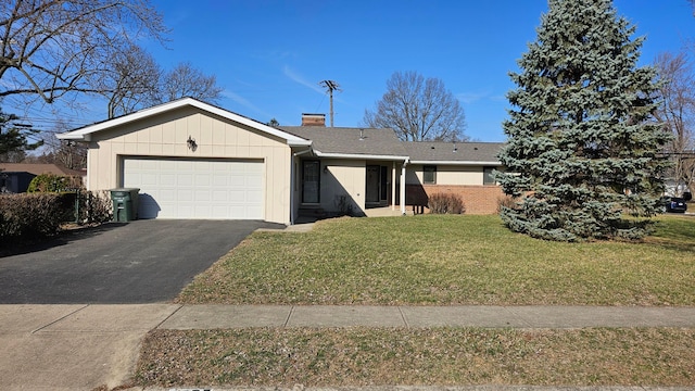 single story home featuring aphalt driveway, a front yard, a chimney, and an attached garage