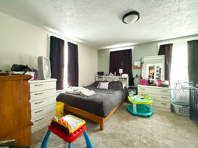 bedroom featuring a textured ceiling and carpet