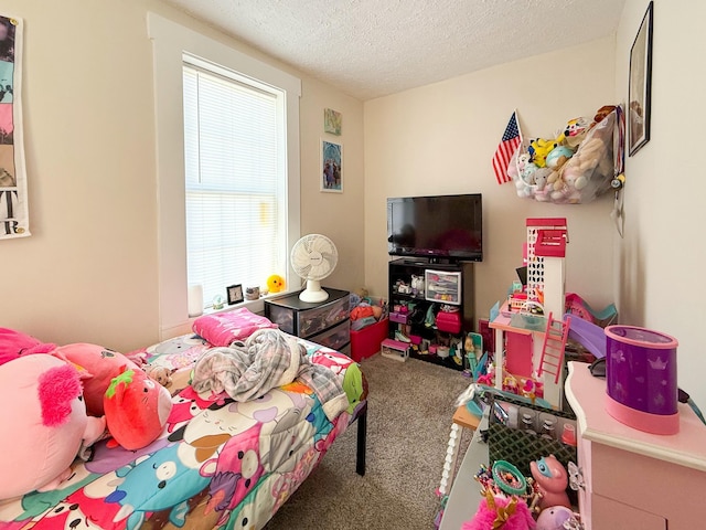 bedroom with multiple windows, a textured ceiling, and carpet