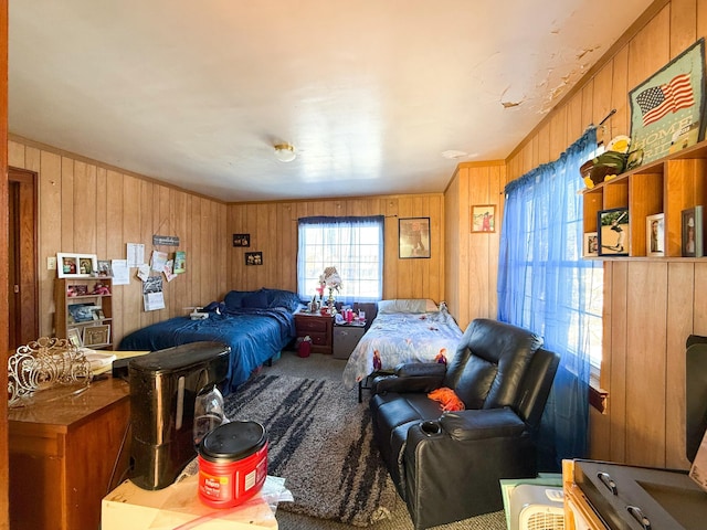 bedroom featuring carpet flooring and wooden walls