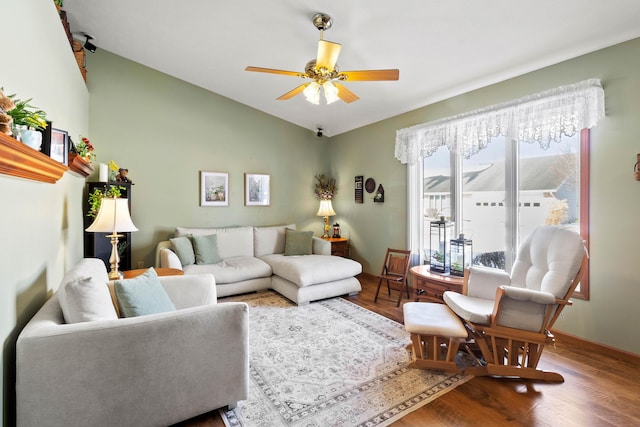 living room featuring ceiling fan, wood-type flooring, and lofted ceiling