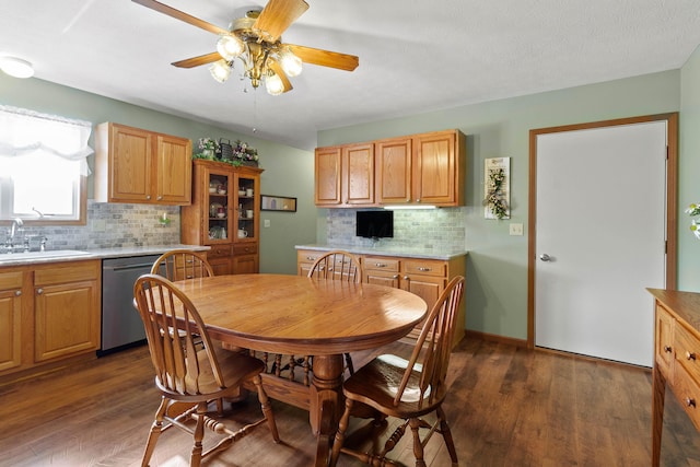 dining room with dark wood-type flooring, ceiling fan, and sink