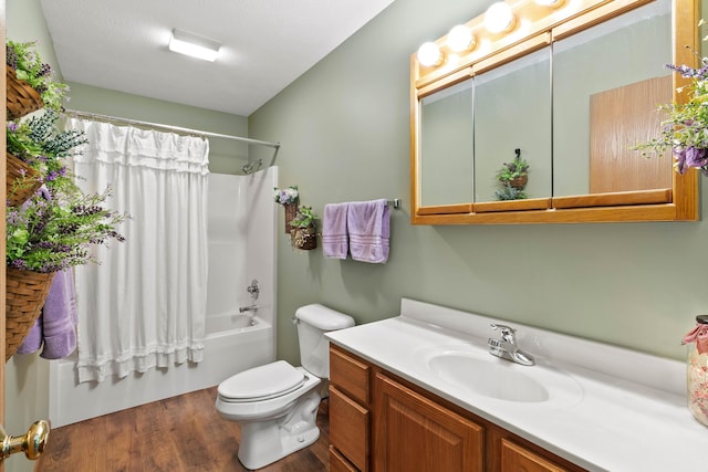 full bathroom with hardwood / wood-style floors, a textured ceiling, shower / bathtub combination with curtain, vanity, and toilet