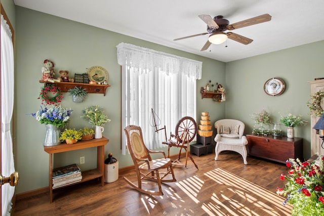 sitting room featuring ceiling fan and dark hardwood / wood-style flooring