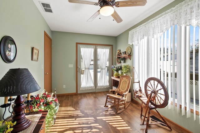 sitting room featuring ceiling fan, french doors, and dark hardwood / wood-style flooring