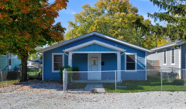 bungalow-style home with covered porch and a front lawn