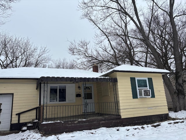 view of front of property featuring cooling unit and a garage