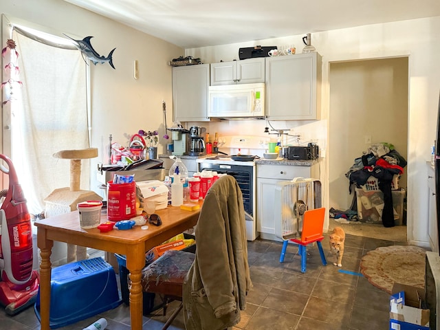 kitchen with white cabinets and electric range