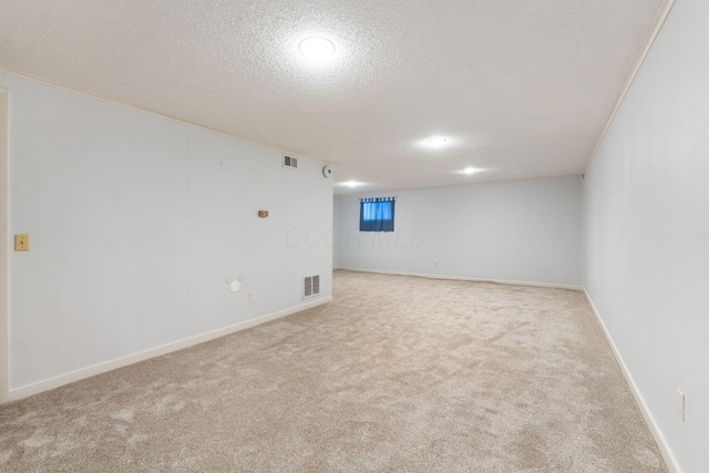 carpeted spare room with a textured ceiling and ornamental molding