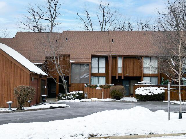 view of snow covered back of property