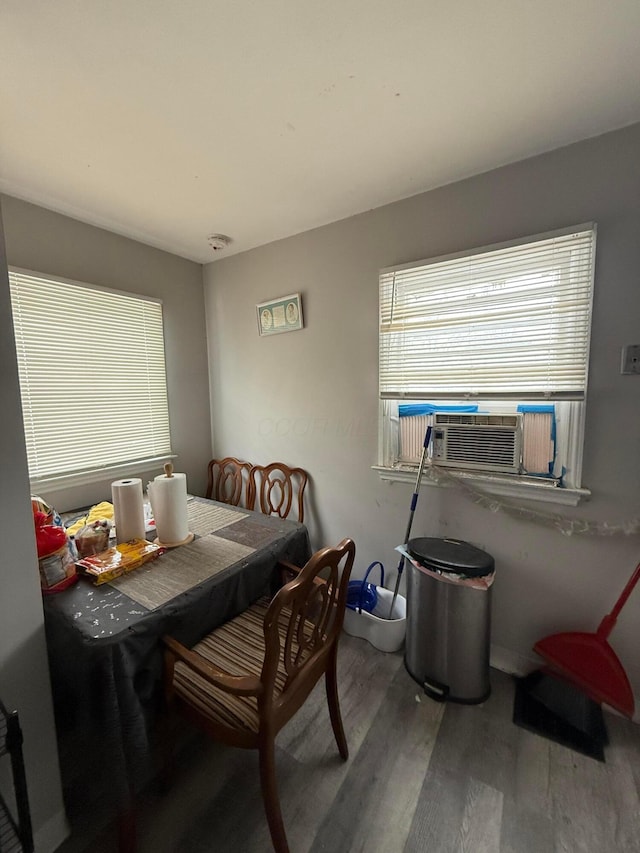 dining room with wood-type flooring and cooling unit