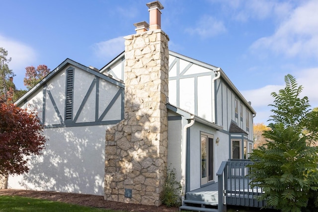 view of side of home with a deck