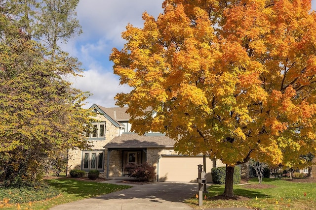 view of front of property with a garage and a front lawn