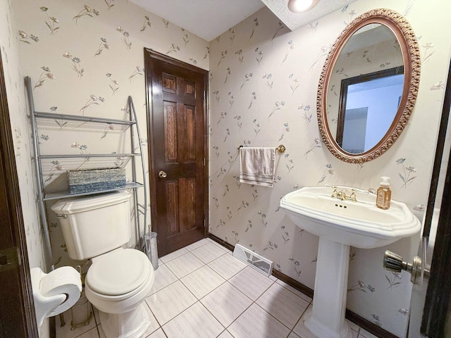 bathroom featuring sink, tile patterned flooring, and toilet