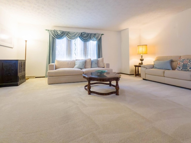 living room with a textured ceiling and carpet floors