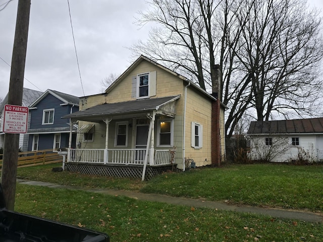 bungalow featuring a front yard and covered porch