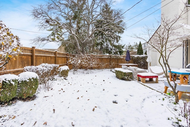 view of yard layered in snow