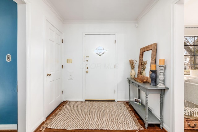 entrance foyer with dark wood-type flooring and ornamental molding