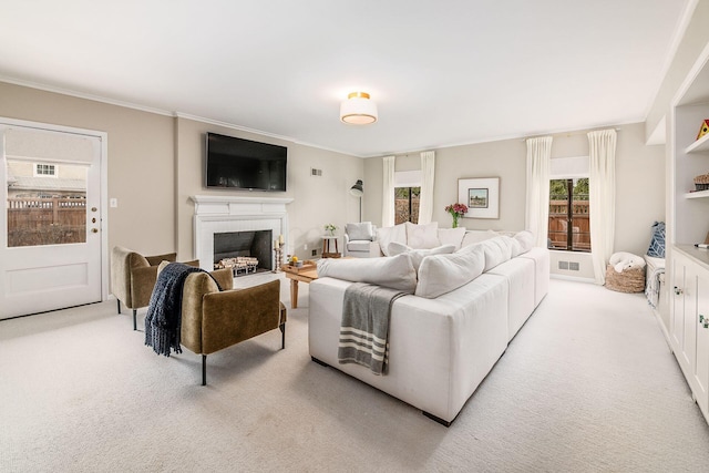 living room featuring crown molding, a brick fireplace, and light carpet