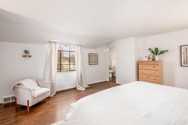 bedroom featuring lofted ceiling and dark hardwood / wood-style floors