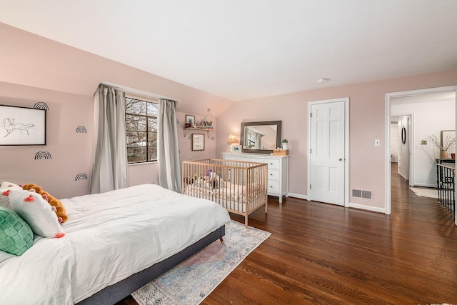 bedroom with dark hardwood / wood-style flooring and vaulted ceiling