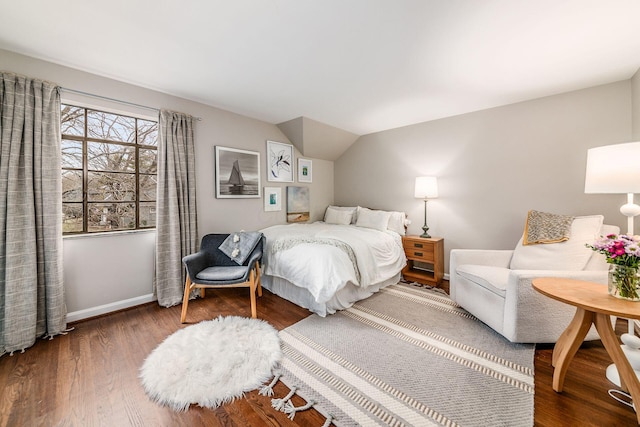 bedroom with lofted ceiling and hardwood / wood-style floors