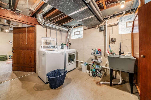 laundry room with separate washer and dryer and sink