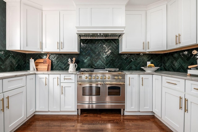 kitchen with white cabinetry, backsplash, dark hardwood / wood-style flooring, range with two ovens, and custom exhaust hood