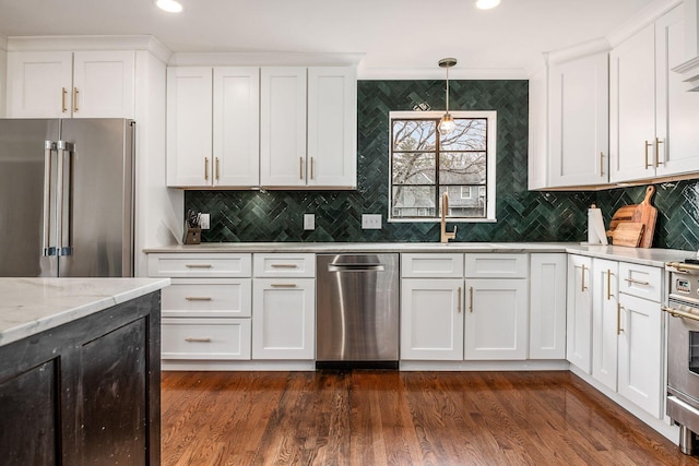 kitchen featuring white cabinetry, light stone countertops, pendant lighting, and stainless steel appliances