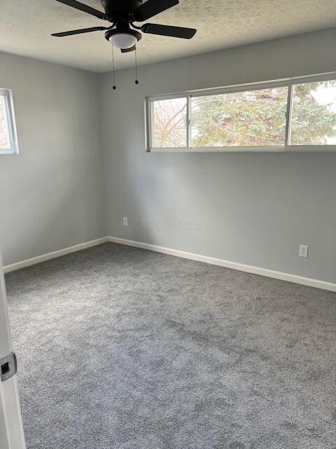 carpeted empty room with ceiling fan