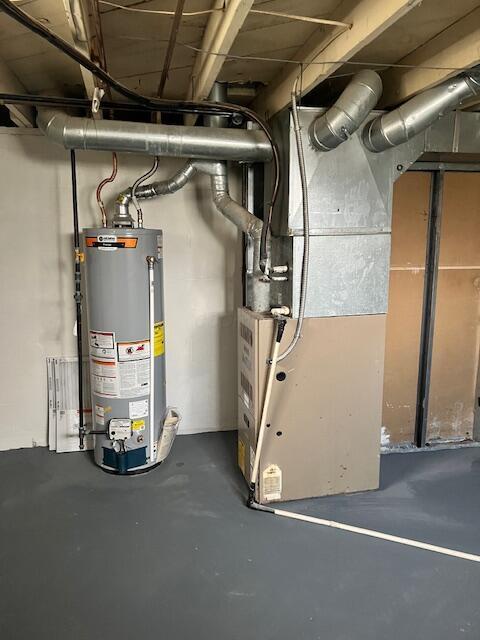 utility room with heating unit and gas water heater