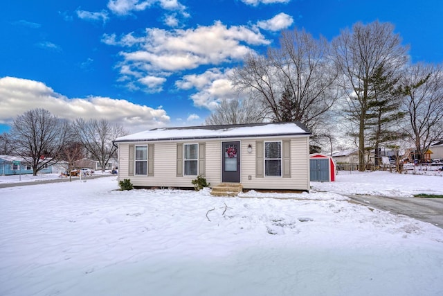 view of front of home with an outbuilding and a storage shed