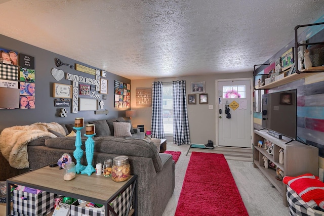 living room featuring light colored carpet and a textured ceiling