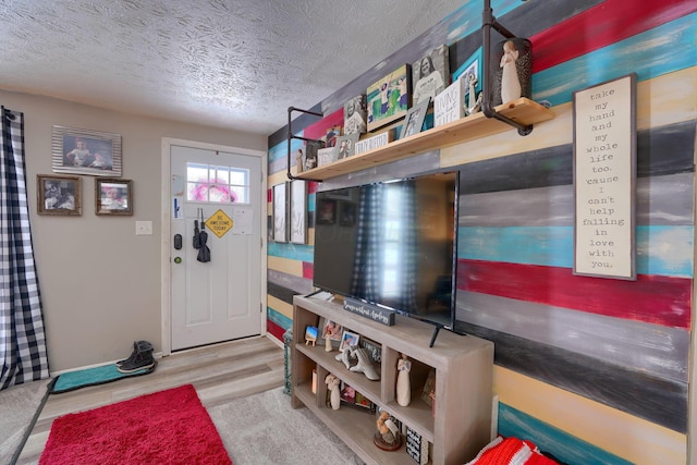 interior space featuring a textured ceiling and wood finished floors