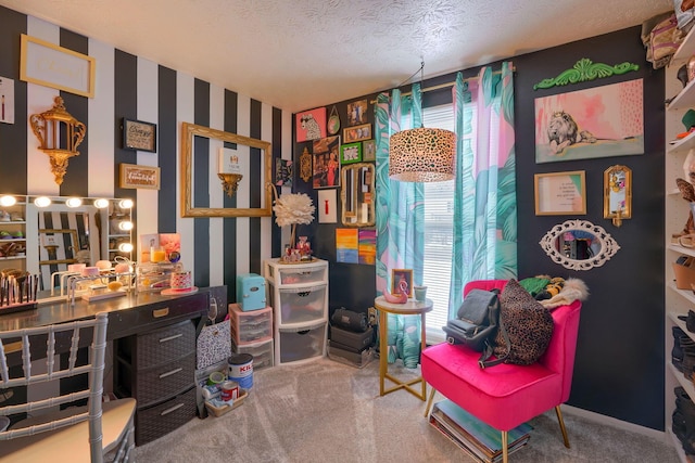 carpeted office space with a textured ceiling and wallpapered walls