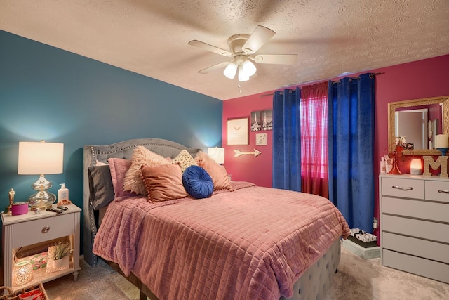 carpeted bedroom featuring a textured ceiling and ceiling fan