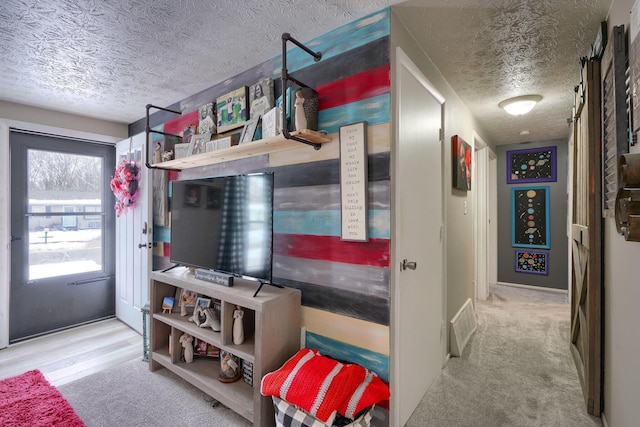 interior space featuring visible vents, a textured ceiling, and carpet floors