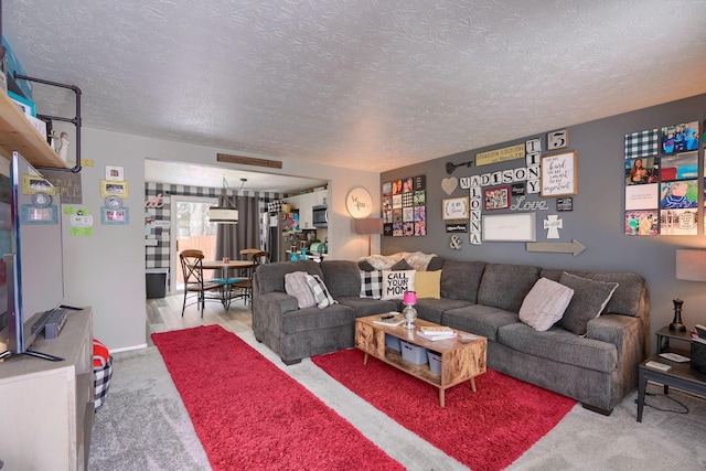 carpeted living room featuring a textured ceiling