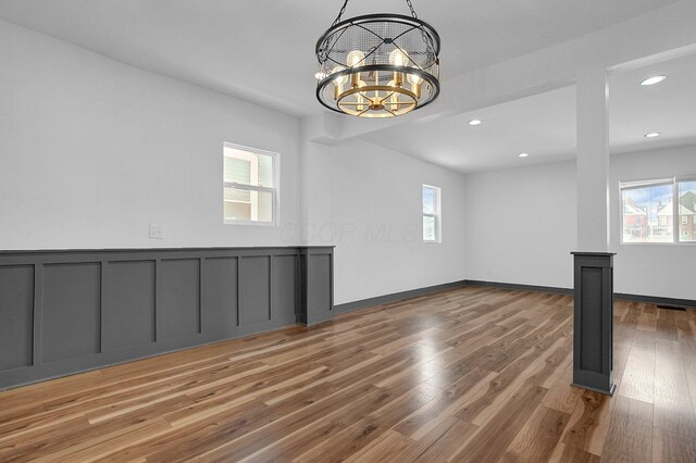 262 N 17th St, Columbus, OH 43203 - empty room with a notable chandelier, wood-type flooring, and plenty of natural light