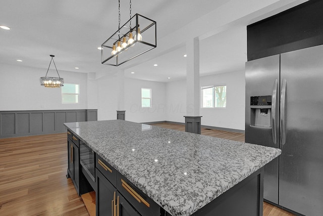 262 N 17th St, Columbus, OH 43203 - kitchen featuring decorative light fixtures, stainless steel fridge, light hardwood / wood-style flooring, and a center island