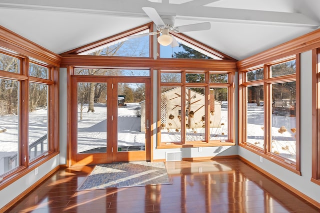 unfurnished sunroom with lofted ceiling, ceiling fan, and a wealth of natural light