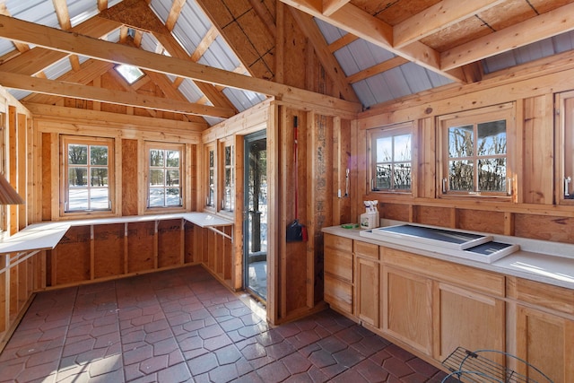 kitchen featuring lofted ceiling and light brown cabinetry