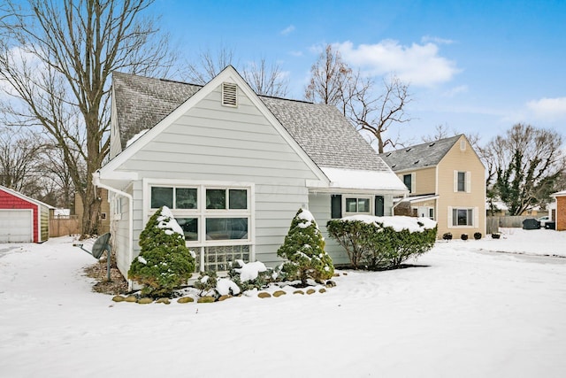 exterior space with a garage and an outbuilding