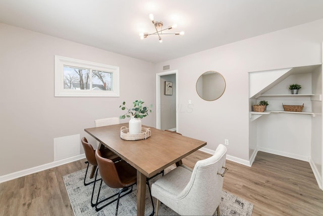 dining room with a notable chandelier and wood-type flooring